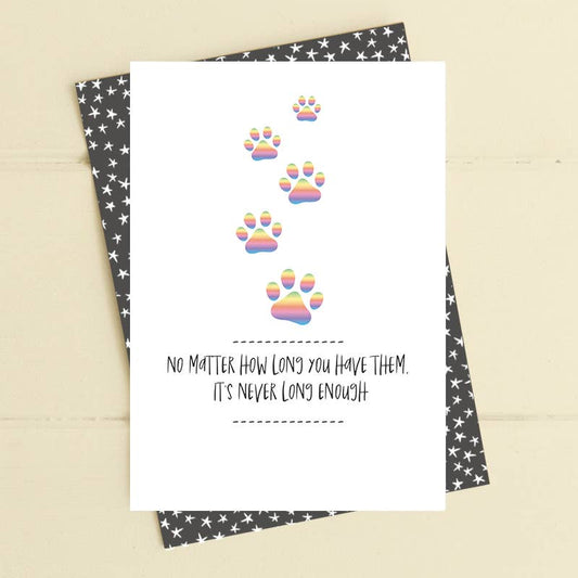 Card with rainbow paw prints and text on a star-patterned envelope