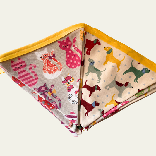 Bunting fabric with cat and dog patterns on a white background