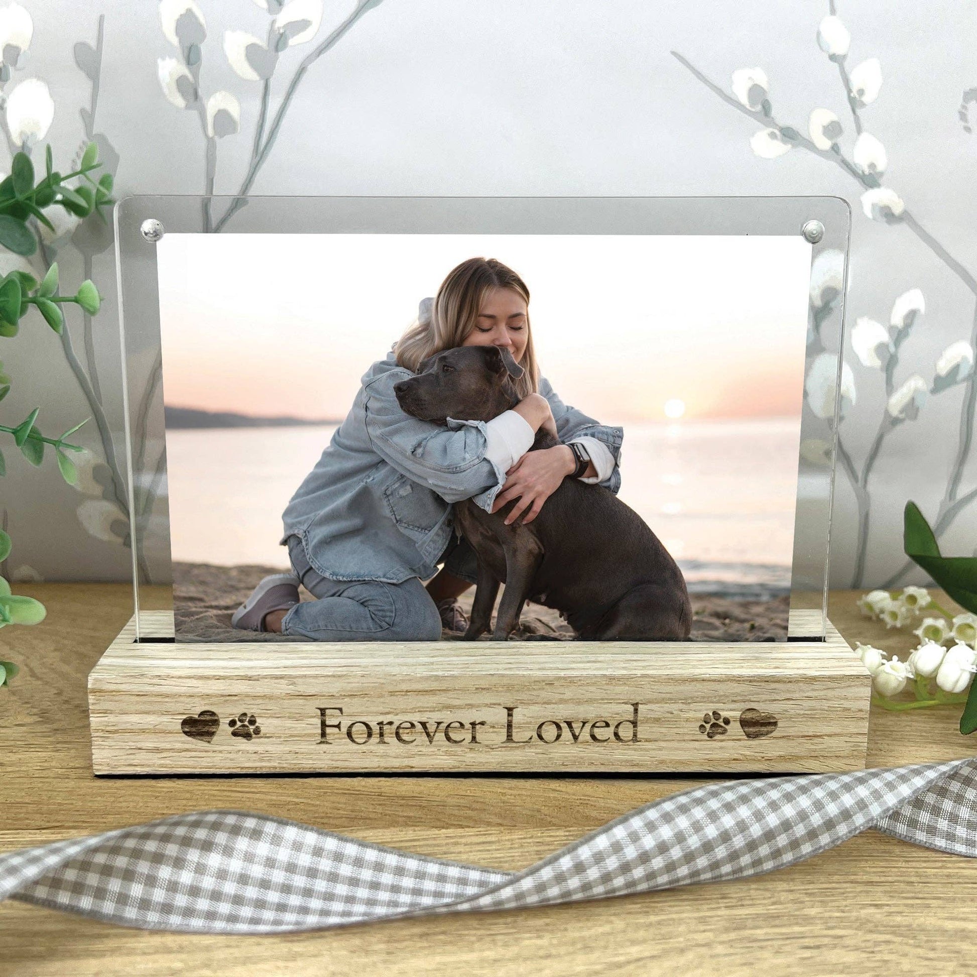 Memorial photo frame with a woman and dog on a beach, engraved with 'Forever Loved'.