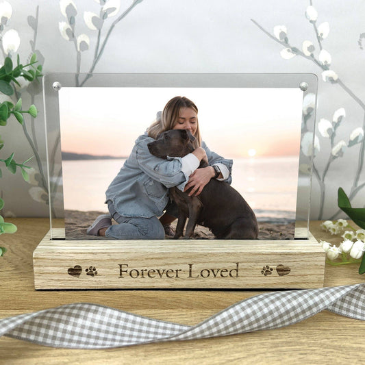 Memorial photo frame with a woman and dog on a beach, engraved with 'Forever Loved'.
