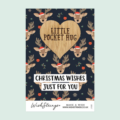 Christmas-themed card with reindeer and heart design on a blue background