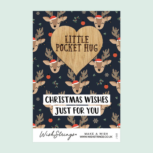 Christmas-themed card with reindeer and heart design on a blue background