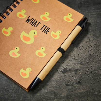 a notepad and pen set saying 'what the duck' with images of yellow ducks printed over the front cover.