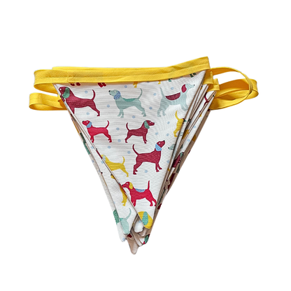 Set of colorful fabric flags with dog pattern on a white background